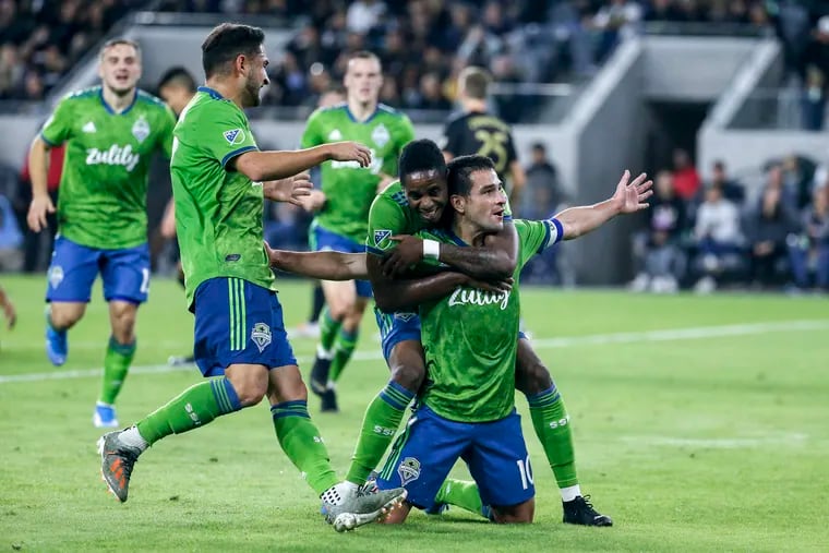 Seattle Sounders midfielder Nicolas Lodeiro (10) celebrates with teammates after scoring a goal during the first half.