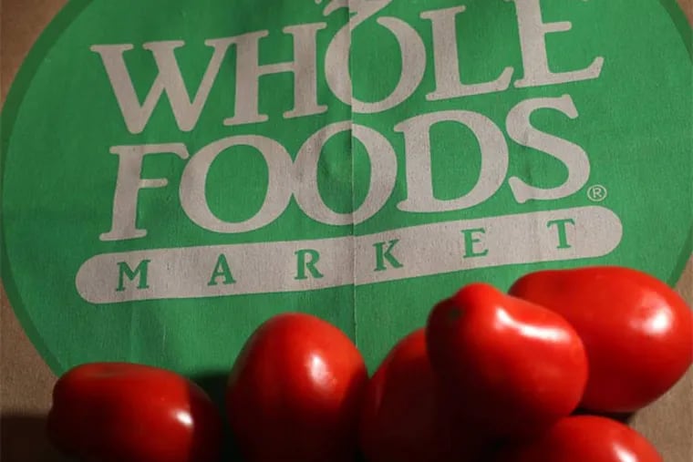 FILE - In this Monday, July 29, 2013,  file photo, produce is places on Whole Foods paper bag in Andover, Mass.  Whole Foods Market Inc. reports quarterly financial results after the market closes on Wednesday, Nov. 6, 2013. (AP Photo/Elise Amendola, File)