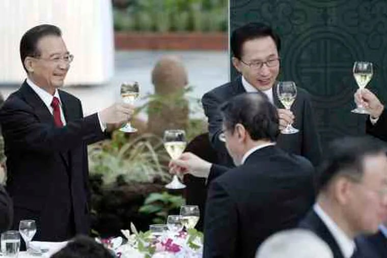 At a weekend summit in South Korea , leaders (from left) Wen Jiabao of China, Lee Myung-bak of South Korea, and Yukio Hatoyama of Japan toast. Saturday's talks focused on trade.