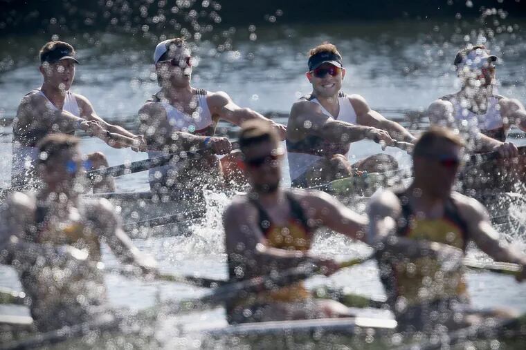 The St. Joseph’s varsity men’s heavyweight 8 team, rear, and Drexel, foreground, compete in their semifinal race during the 80th annual Dad Vail Regatta on the Schuylkill on Friday.