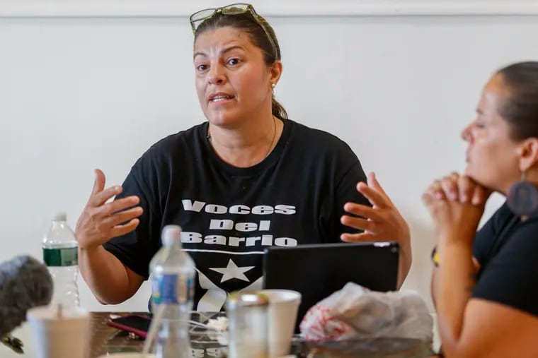 The Rev. Jessie Alejandro, of Voces del Barrio, speaks of the triumph of the protestors in Puerto Rico to oust the governor as she has lunch with friends at El Coquí in Philadelphia on July 25, 2019.