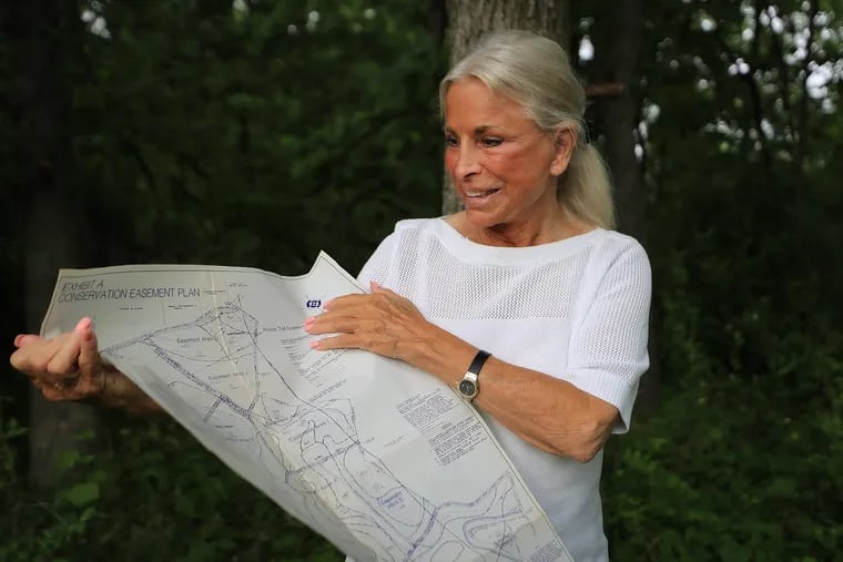 Carol McCloskey, of Newtown Square, looks over a property map of a plot of land in the Brandywine Valley in Chester County, Pa. McCloskey owns a half acre plot on what's known as Indian Knoll and designated by the county as a historical Native American burial site of the Lenape.