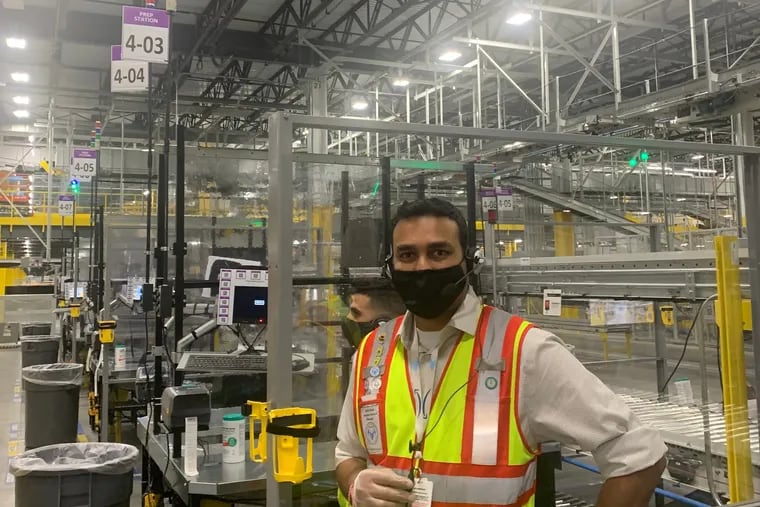 Jairaj Vora, a manager at Amazon's giant facility in Stanton, near Wilmington, Del. stands inside the $250 million warehouse.