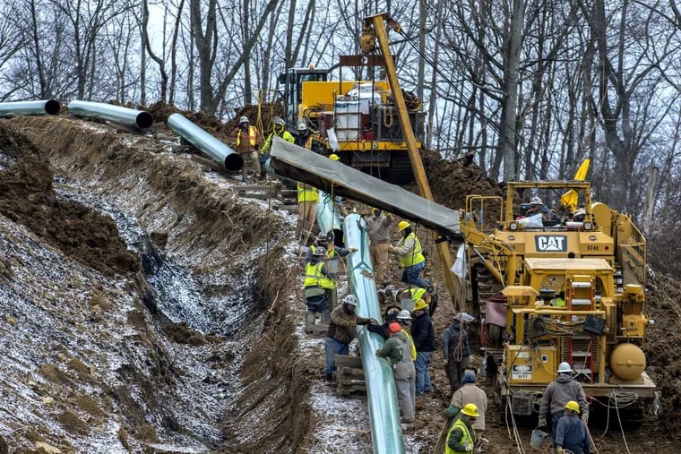 Workers install the Mariner East 2 pipeline last year in Washington County, Pa.
