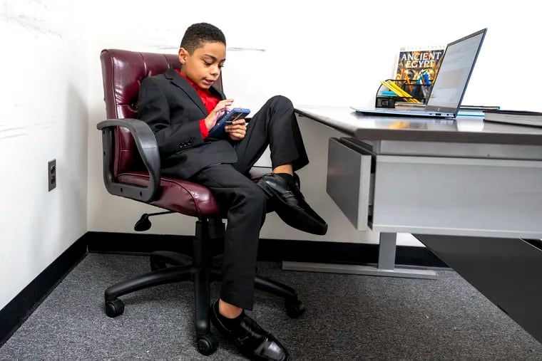 9-year-old wunderkind David Balogun at his desk at his father’s office in Bensalem. Balogun just graduated from high school, one of the youngest people ever to do so. He's into black holes and astrophysics, and his family is helping him figure out where to attend college.