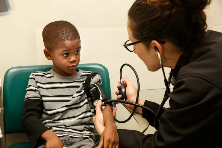 Five-year-old Sha-Zere Jackson has his blood pressure checked by Dr. Laura Deutsch, a 3rd year Pediatric Resident at Cooper Hospital, in Camden, N.J.