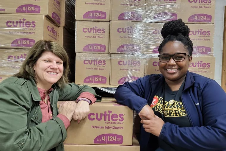 “I really wanted to start distributing directly to the public out of the warehouse, just to give back to the community that has been home to us for so long,” said Deneen Newland (right), operations manager for the Greater Philadelphia Diaper Bank. Mauri Rapp (left) and Newland distribute diapers from their Kensington warehouse.