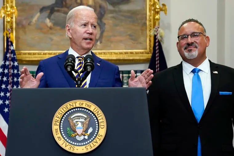 President Joe Biden speaking about student loan debt forgiveness in the Roosevelt Room of the White House on Aug. 24. Education Secretary Miguel Cardona listened at right.