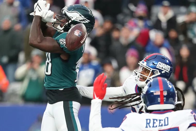 Eagles receiver Jalen Reagor can't hang on to a pass as New York Giants cornerback Aaron Robinson (center) defends late in the fourth quarter.