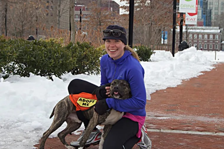 Carrie Maria trains with one of her partners. She founded a group that borrows dogs from shelters as running mates, which helps calm the dogs and make them more adoptable.