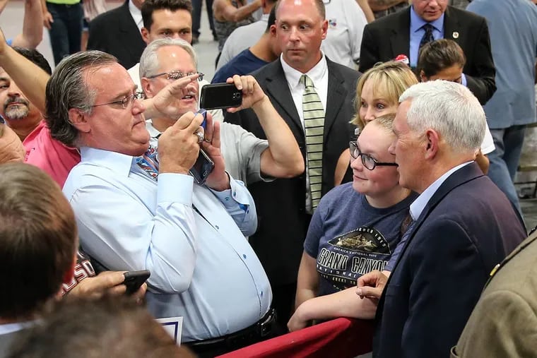 Republican vice presidential nominee Mike Pence take a photo with supporters after speaking at Worth and Co. in Pipersville, Bucks County, on Tuesday, Aug. 23, 2016.