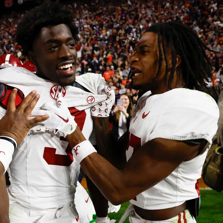 Alabama defensive back Terrion Arnold (3) celebrates with linebackers Jeremiah Alexander, left, and Trezmen Marshall, right, after an interception to end an NCAA college football game against Auburn, Saturday, Nov. 25, 2023, in Auburn, Ala. (AP Photo/Butch Dill)