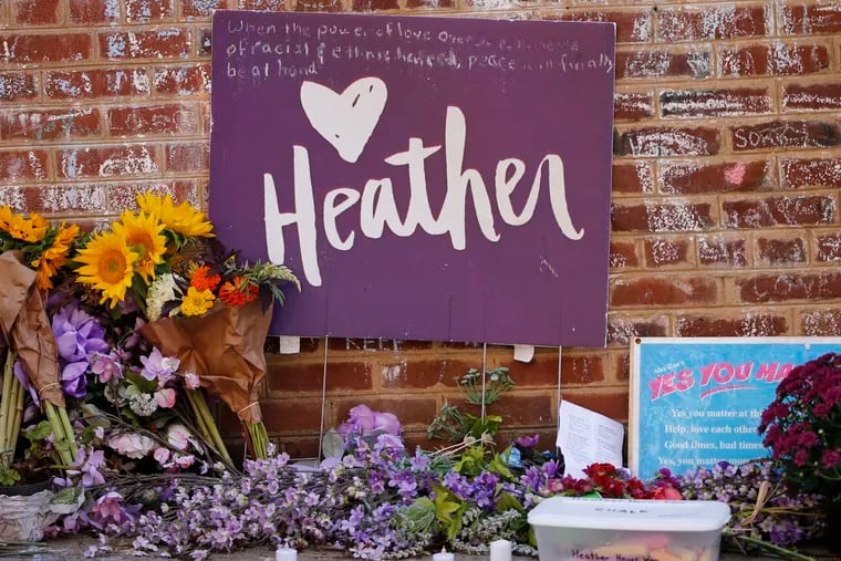 Flowers and signs decorated the site of a memorial to Heather Heyer who died during the Unite the Right rally in 2017 in Charlottesville, Va., Monday, Aug. 12, 2019.
