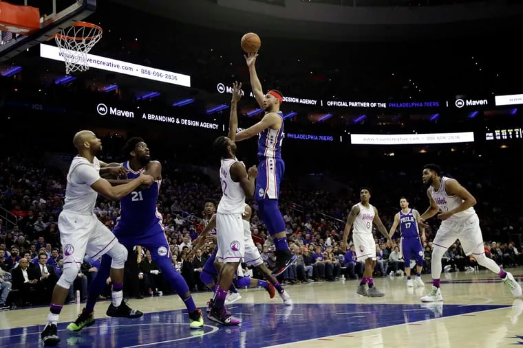 Sixers point guard Ben Simmons puts up a shot over Timberwolves wing Andrew Wiggins on Tuesday.