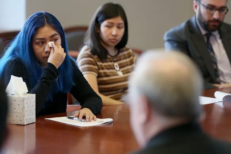 Dreamer Evelyn Márquez Auza becomes emotional while sharing her story during a listening session with fellow Dreamers and Bishop Dennis Sullivan at the Roman Catholic Diocese of Camden office.