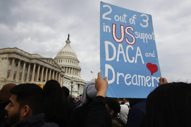 A woman holds up a sign outside the Capitol in support of the Deferred Action for Childhood Arrivals (DACA) program Tuesday on Capitol Hill in Washington.