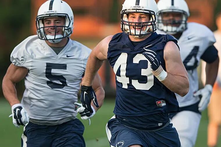 Penn State linebacker Mike Hull smiles while running sprints during football practice Wednesday, Oct. 1, 2014 in State College, Pa. (AP Photo/PennLive.com, Joe Hermitt)