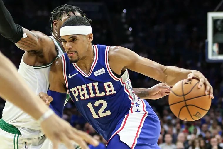 Sixers' Tobias Harris drives on Celtics' Marcus Smart during the 3rd quarter of the season home opener at the Wells Fargo Center on Wednesday.
