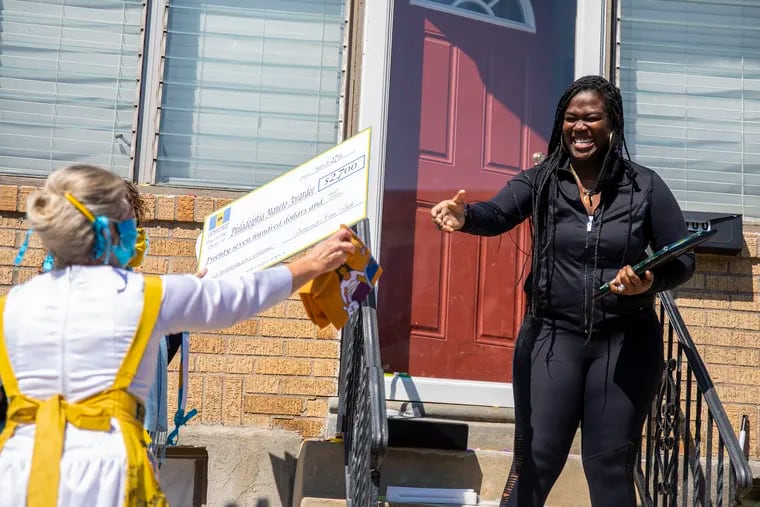 Brenda Exon, Co-Founder and Executive Director with Partners for Civic Pride, (left), gives a $2,500 check and plaque to Victoria Wylie, Donte Wylie Foundation, (right), for the Philadelphia Maneto Award for Prosperity on Thursday, May 7, 2020. Wylie created the foundation from losing her brother Donte Wylie to gun violence back in 2008. “This is what I do from my heart,” Wylie said. “It’s always nice to see that people recognize the work you’re doing and I’m honored. I feel like It’s my duty and responsibility to give back.”