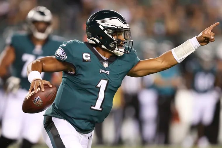 Eagles quarterback Jalen Hurts points running with the football against the Tampa Bay Buccaneers during the first quarter on Thursday, October 14, 2021 in Philadelphia.