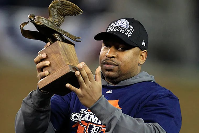 Detroit Tigers' Delmon Young holds the most valuable player trophy after his team won Game 4 of the American League championship series, 8-1, against the New York Yankees, Thursday, Oct. 18, 2012, in Detroit. The Tigers move on to the World Series. (AP Photo/Carlos Osorio)