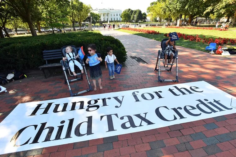 Parents and caregivers with the Economic Security Project gathered outside the White House to advocate for the child tax credit in September.
