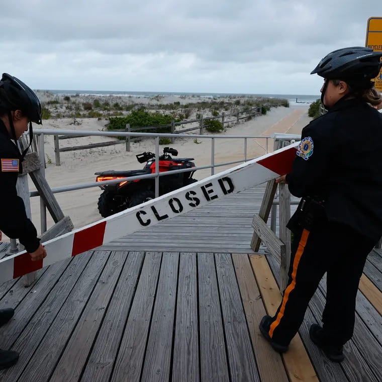 Ocean City Police officers close off beach access at the 8 p.m. curfew. Last year, the Shore town moved up its teen curfew to 11 p.m., closed beaches, and banned backpacks after 8 p.m., and closed boardwalk bathrooms after 10 p.m.