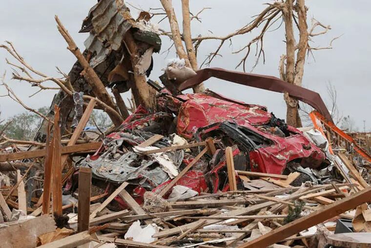 The twister that hit Moore, Okla., left a 17-mile path of destruction. Moore's debris could cover an NBA court to a depth of 1.7 miles, according to estimates. (SUE OGROCKI / Associated Press)
