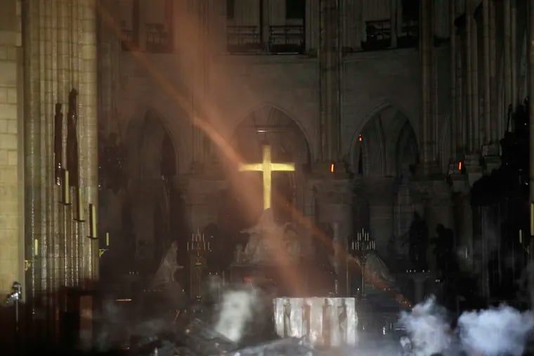 Smoke is seen around the altar inside Notre Dame cathedral in Paris, Monday, April 15, 2019. A catastrophic fire engulfed the upper reaches of Paris' soaring Notre Dame Cathedral as it was undergoing renovations Monday, threatening one of the greatest architectural treasures of the Western world as tourists and Parisians looked on aghast from the streets below. (Philippe Wojazer / Pool via AP)