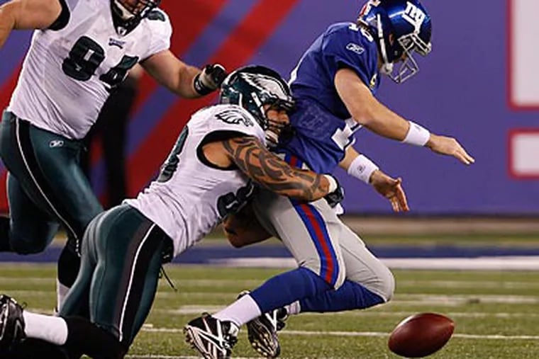 Jason Babin caused a crucial fumble against Giants quarterback Eli Manning late in the fourth quarter. (David Maialetti/Staff Photographer)
