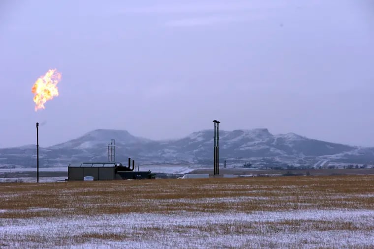 In this 2015 photo, a gas flare is seen at a natural gas processing facility near Williston, N.D.