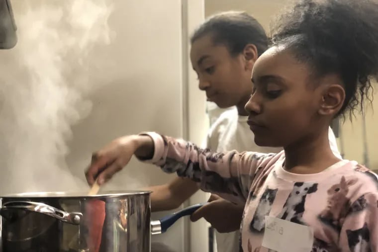 Leila Anderson and Zayniyah Mercado learn to make Moroccan stew during week four of the spring 2019 My Daughter's Kitchen cooking program at Sacred Heart.