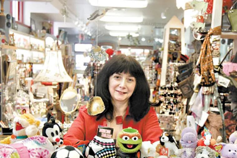 Sherry Tillman behind the counter in her store in Ardmore. (Bonnie Weller / Staff Photographer)