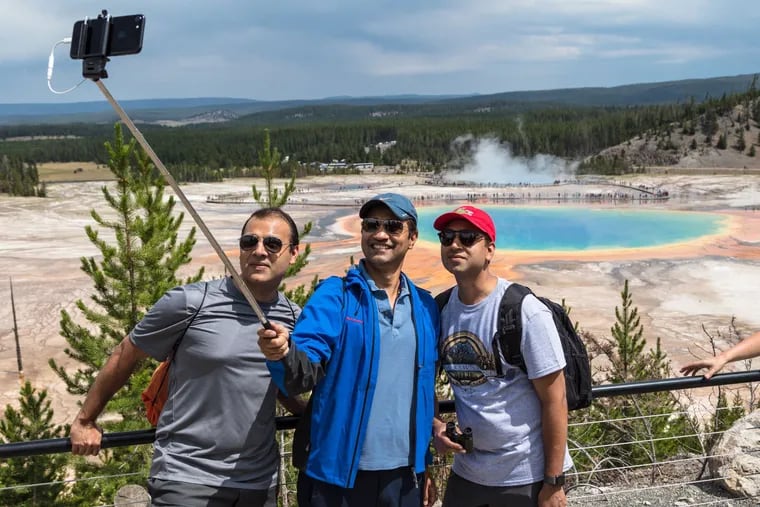 A safe way to take a selfie -- staying on the trail and behind the barrier -- at Yellowstone National Park on the Grand Prismatic Spring Overlook Trail.