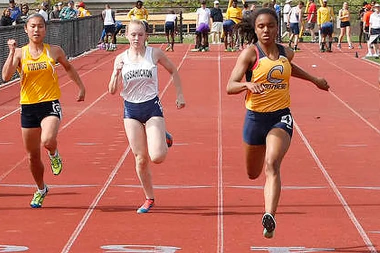 Cheltenham's Katelyn Jackson (center) wins the 100-meter dash, running it in 12 seconds flat.