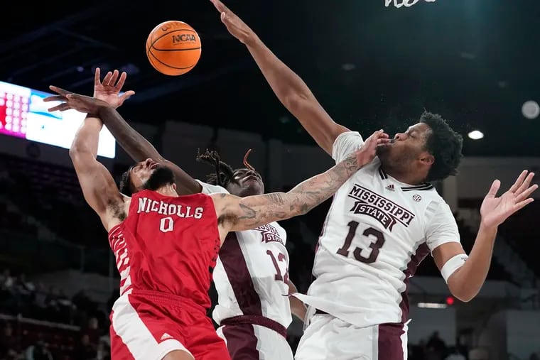 Nicholls State forward Marek Nelson has his shot blocked as he has contact from Mississippi State forward KeShawn Murphy while making contact with forward Will McNair Jr. (13).