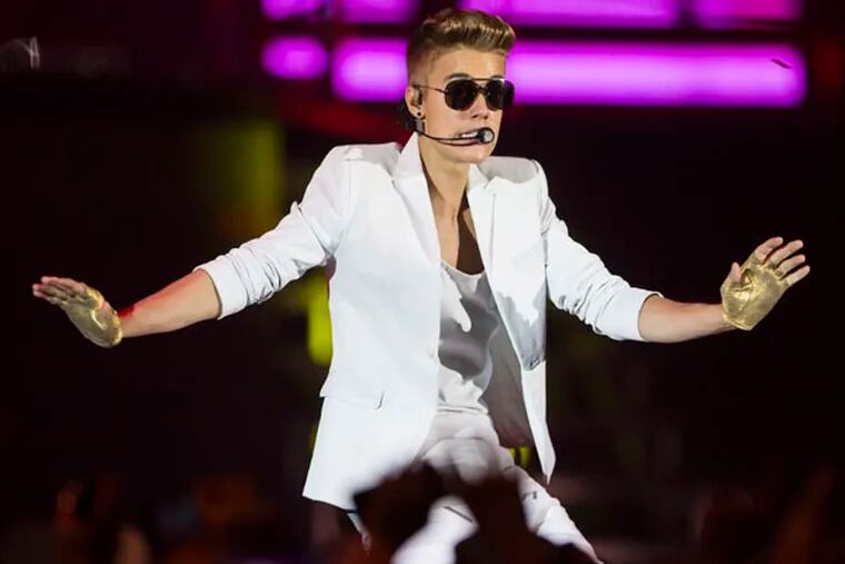 FILE - A Sunday, March 31, 2013 photo from files showing Canadian singer Justin Bieber performing on stage during the "I Believe Tour " in Berlin, Germany. (AP Photo/Gero Breloer)