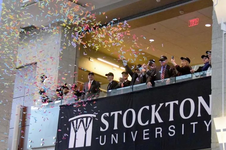A cloud of confetti greets the official naming of Stockton University at a campus celebration in Pomona, N.J., on Wednesday. The 44-year-old school has broken enrollment records four years in a row.