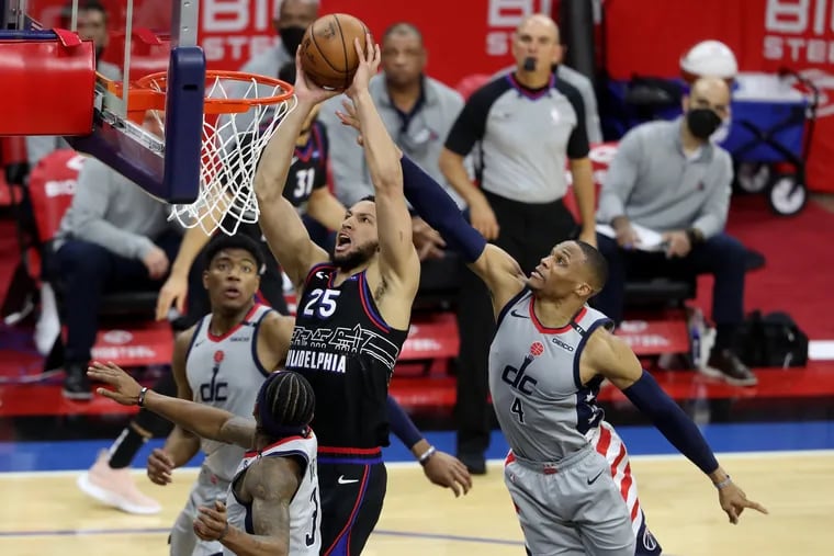 Ben Simmons dunks against Russell Westbrook, right, of the Wizards during Game 2.