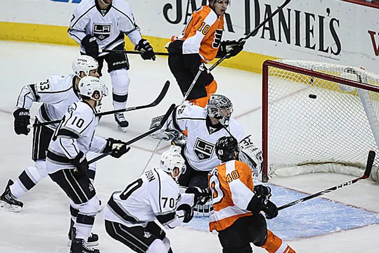 The Flyers' Vincent Lecavalier and Brayden Schenn watch as the puck hits the right post, the crossbar and the left post in a loss against the Kings. (Steven M. Falk/Staff Photographer)