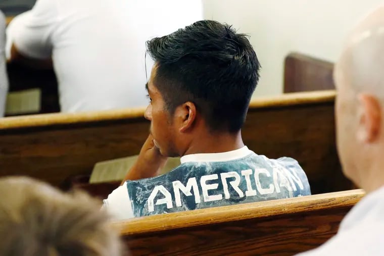 A Latino youth wears a t-shirt that has "American" written on the back at a Spanish Mass at Sacred Heart Catholic Church in Canton, Miss., on Sunday. Churches have been key to providing spiritual and emotional comfort to workers following immigration raids at seven Mississippi poultry plants.