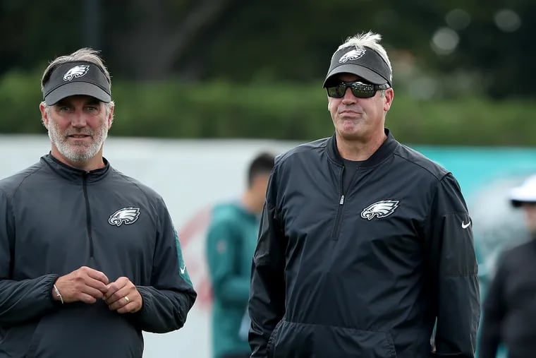 Doug Pederson (right) watches training camp on Thursday.