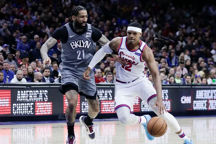 Sixers forward Tobias Harris dribbles the basketball past Brooklyn Nets forward Wilson Chandler on Thursday, February 20, 2020 in Philadelphia.