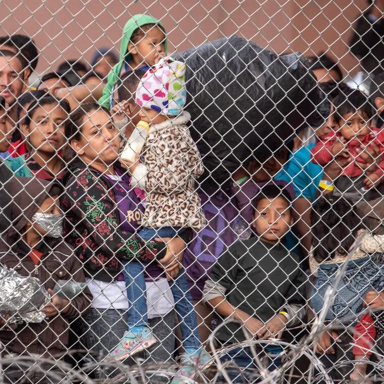 Migrants are gathered inside the fence of a makeshift detention center in El Paso, Texas, in 2019.