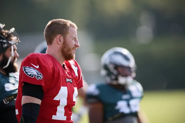 Quarterback Carson Wentz walks across the field during Eagles training camp at the NovaCare Complex in South Philadelphia on Saturday, July 27, 2019.
