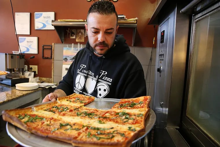 Alessandro Cocuzza works in the family's shop, Powelton Pizza, a shop in University City owned and operated by the Cocuzza family from Sicily.