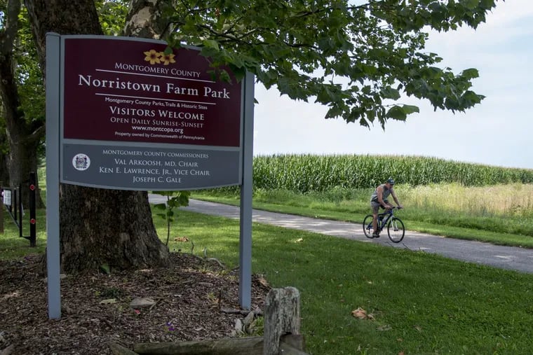 A bicyclist rides through Norristown Farm Park August 2, 2017, a day after a woman was sexually assaulted at gunpoint in the park.