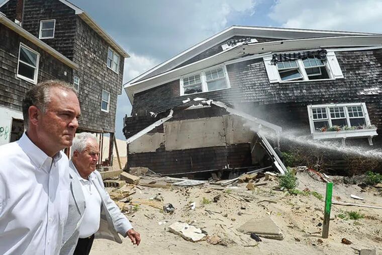 File: DEP Commissioner Bob Martin (foreground) and Toms River Mayor Tom Kelaher walk by a home in August 2013 in Toms River that was ravaged by Sandy. Martin told a N.J. Assembly committee on Monday that no long-term funding source for land and historic preservation has been established.