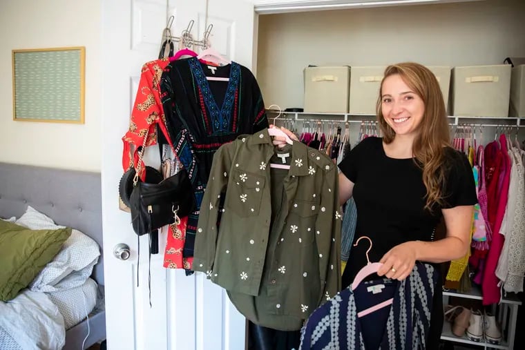 Annie Karlen shows off some of her online thrift purchases at her apartment in the Washington Square section of Philadelphia. Karlen often shops at thredUP, an online consignment and thrift store.