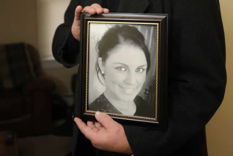 John Machen holds a 2013 photograph of his daughter Steph at Steph's Place facility in Pottstown, Pa.